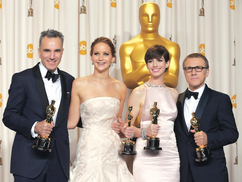 l r actors daniel day lewis jennifer lawrence anne hathaway and christoph waltz pose with their oscars backstage at the 85th academy awards in hollywood photos reuters