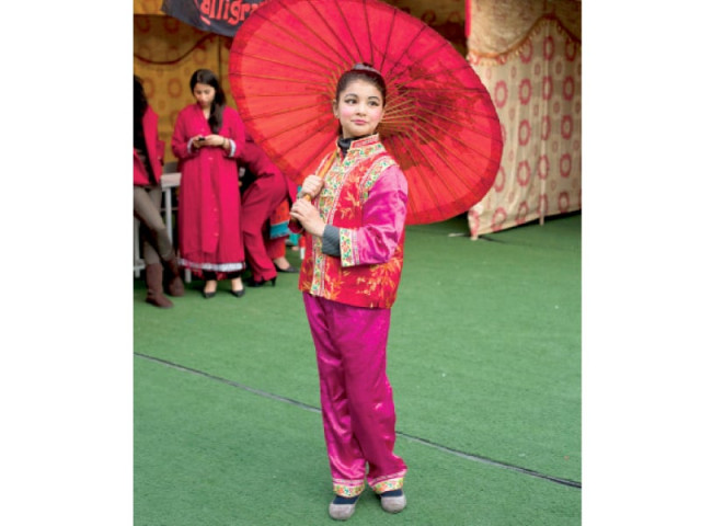 a student poses in traditional chinese costume photo myra iqbal express a student poses in traditional chinese costume photo myra iqbal express