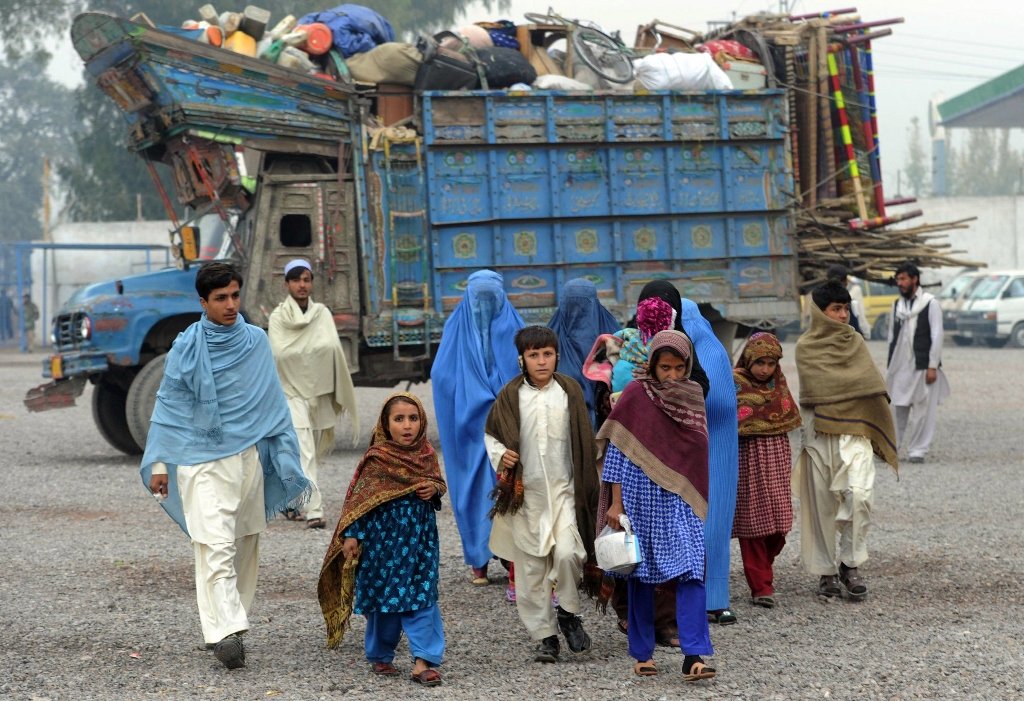 in this picture taken on november 27 2012 afghan refugees arrive at the united nations high commissioner for refugees unhcr registration centre on the outskirts of peshawar before their departure to their home country photo afp