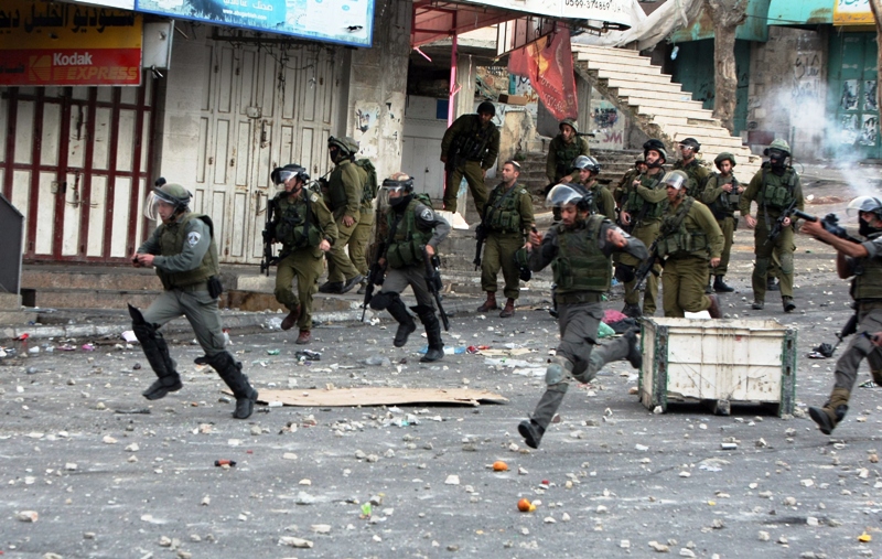 israeli security forces shoot tear gas canisters as they chase palestinian protestors following the funeral of a palestinian man who died in an israeli prison photo afp