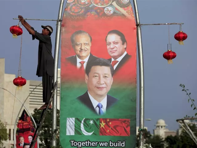 a man hangs decorations next to a banner showing pakistan s president mamnoon hussain l chinese president xi jinping c and pakistan s prime minister nawaz sharif before xi s visit to islamabad april 19 2015 photo reuters a man hangs decorations next to a banner showing pakistan s president mamnoon hussain l chinese president xi jinping c and pakistan s prime minister nawaz sharif before xi s visit to islamabad april 19 2015 photo reuters