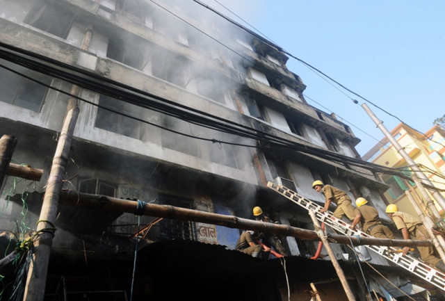 indian firefighters climb a ladder as they attempt to control a blaze in the surya sen market building in kolkata on february 27 2013 photo afp indian firefighters climb a ladder as they attempt to control a blaze in the surya sen market building in kolkata on february 27 2013 photo afp
