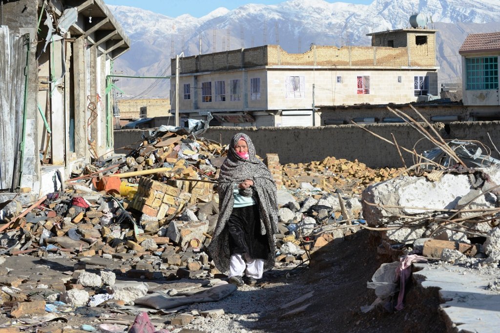 a pakistani hazara resident walking through debris from a bombing on february 16 which killed 89 shia muslims in quetta photo afp