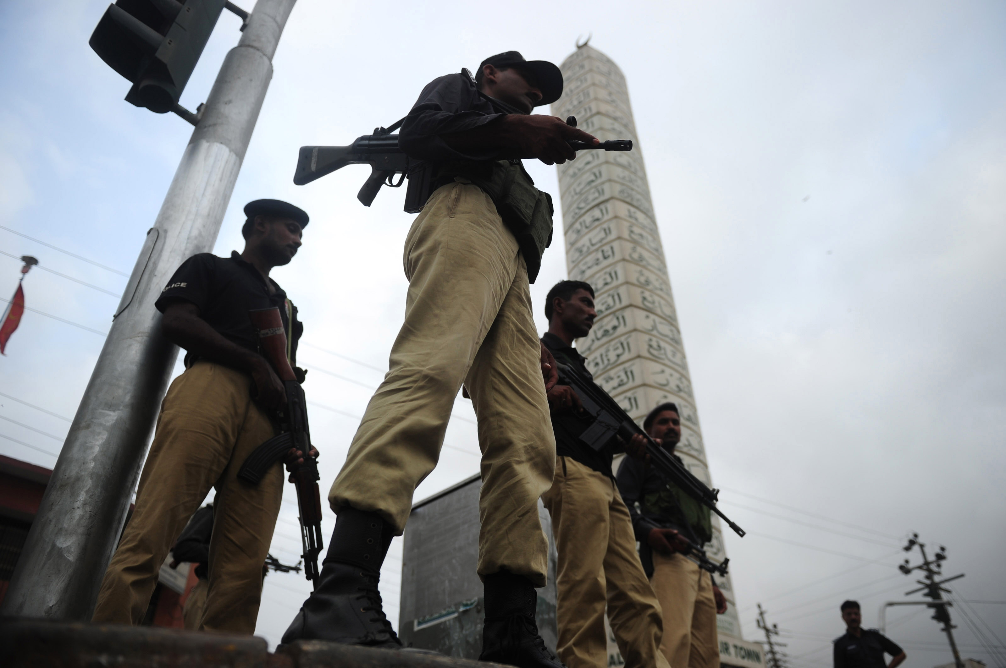 pakistani policemen stand guard in a troubled neighbourhood in karachi photo afp