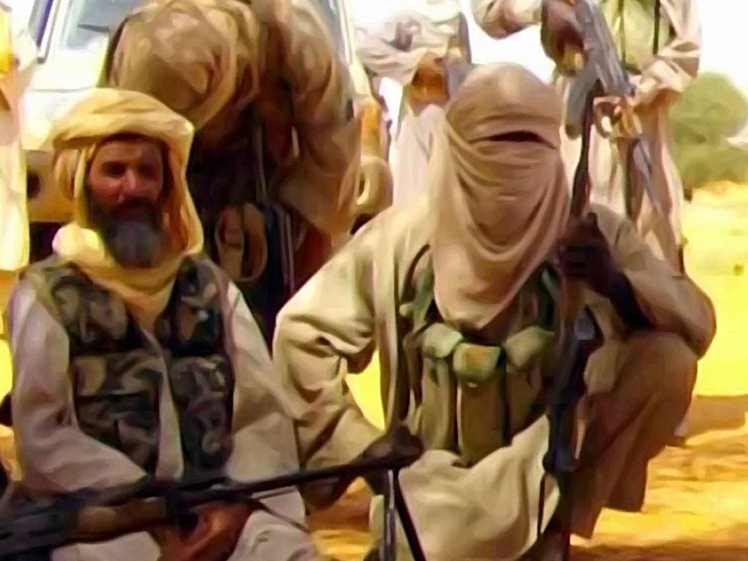 this al andalus image grab from a video released on february 28 2013 shows abu zeid l also known as abid hammadou posing with fighters of al qaeda in the islamic maghreb photo afp