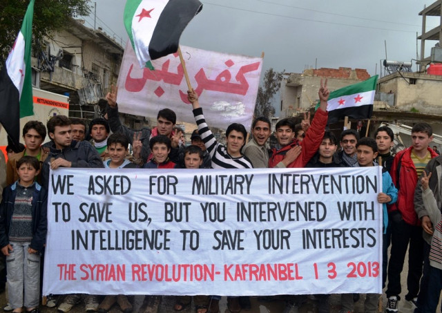 a handout picture released by syria 039 s opposition run shaam news network shows syrian anti government protesters holding a banner against the international community 039 s reluctance to arm rebel forces photo afp a handout picture released by syria 039 s opposition run shaam news network shows syrian anti government protesters holding a banner against the international community 039 s reluctance to arm rebel forces photo afp