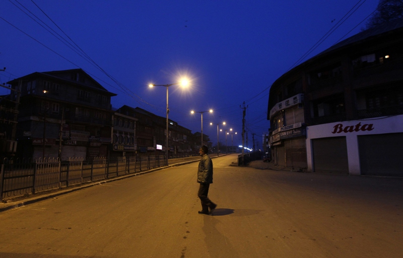 an indian policeman patrols a deserted road during a curfew in srinagar on february 11 2013 photo reuters