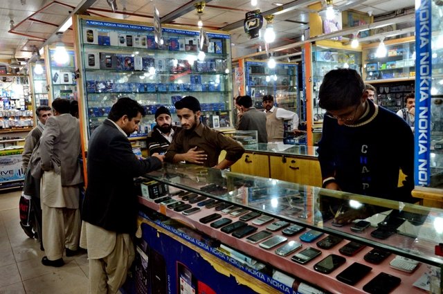 a shopkeeper c bargains with clients in a mobile market in peshawar on march 2 2013 which received threats from the taliban photo afp