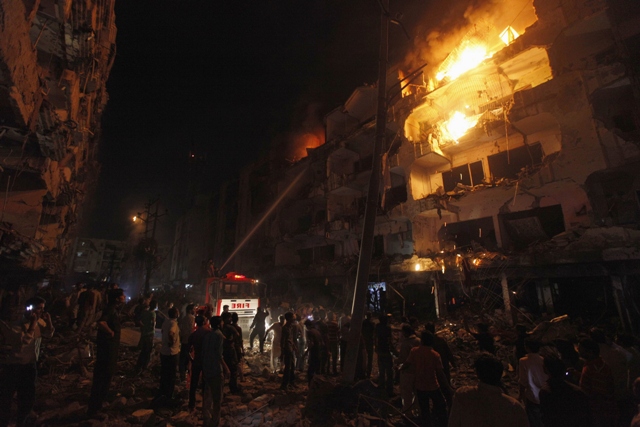 firefighters spray water to control a fire in a building after a bomb blast in a residential area in karachi march 3 2013 photo reuters