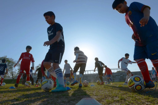 children of the islamabad football academy take part in a practice session at a sports complex in islamabad photo afp children of the islamabad football academy take part in a practice session at a sports complex in islamabad photo afp