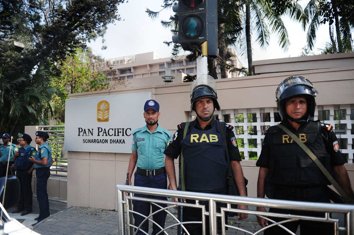 bangladeshi policemen stand guard in front of the hotel where the visiting indian president pranab mukherjee is staying in dhaka on march 4 2013 photo afp