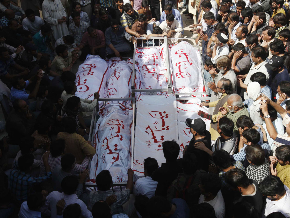 people attend funeral prayer who were killed in bomb attack a day earlier in karachi march 4 2013 photo reuters