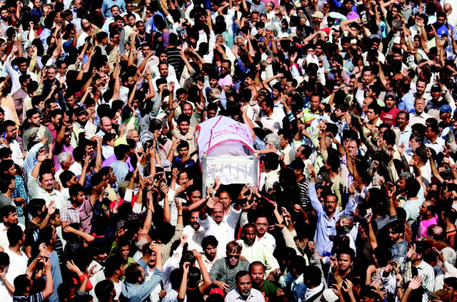 mourners at sharae pakistan prepare to take a body to wadi e hussain graveyard mourners at sharae pakistan prepare to take a body to wadi e hussain graveyard