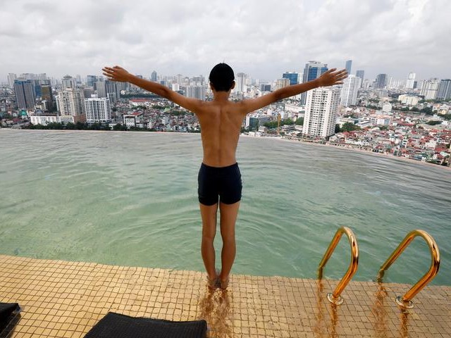 A boy jumps into the water at the gold-plated infinity pool of the newly inaugurated Dolce Hanoi Golden Lake luxury hotel in Hanoi, Vietnam. PHOTO: REUTERS