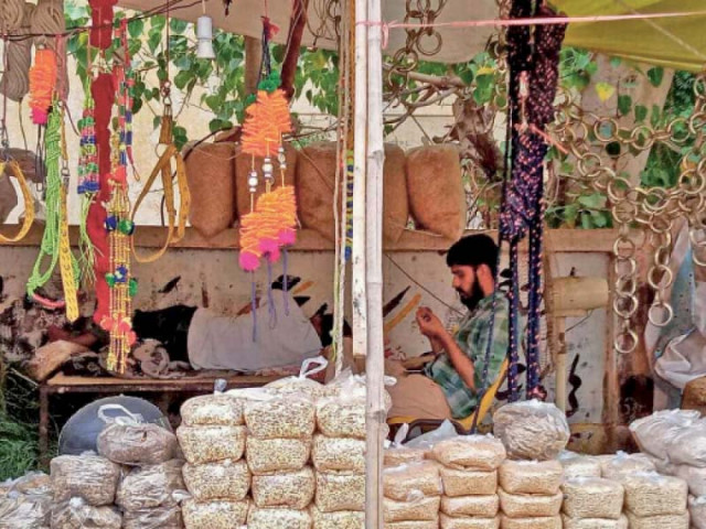 a man awaits customers at a makeshift stall selling animal fodder on the eve of eidul azha such stalls spring up across the city on the occasion giving people a chance to make some extra money photo express a man awaits customers at a makeshift stall selling animal fodder on the eve of eidul azha such stalls spring up across the city on the occasion giving people a chance to make some extra money photo express