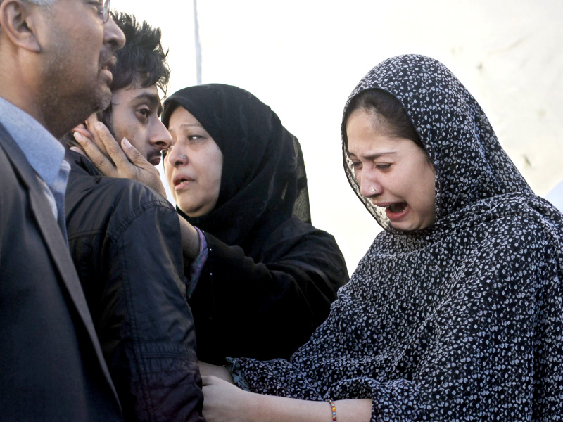family members mourn the death of their relatives in karachi photo reuters