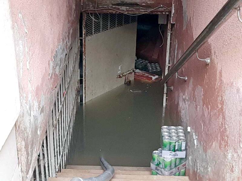 a basement used as a shop warehouse lies inundated with murky water in dha the rainwater has destroyed goods in nu merous such warehouses photo express
