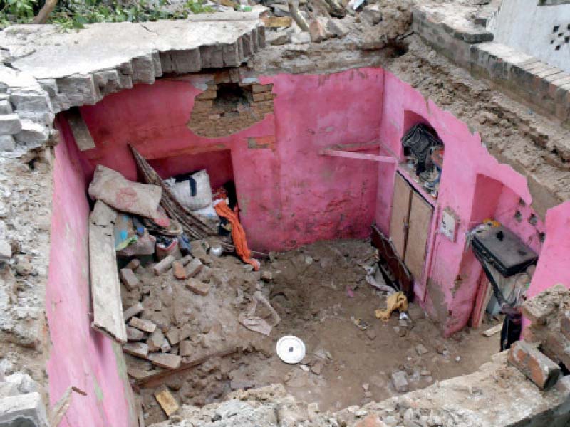 a view of the debris after the roof of a house collapsed in lahore s taxali market several buildings in the old city area have weakened with time however families continue to live in them photo ppi