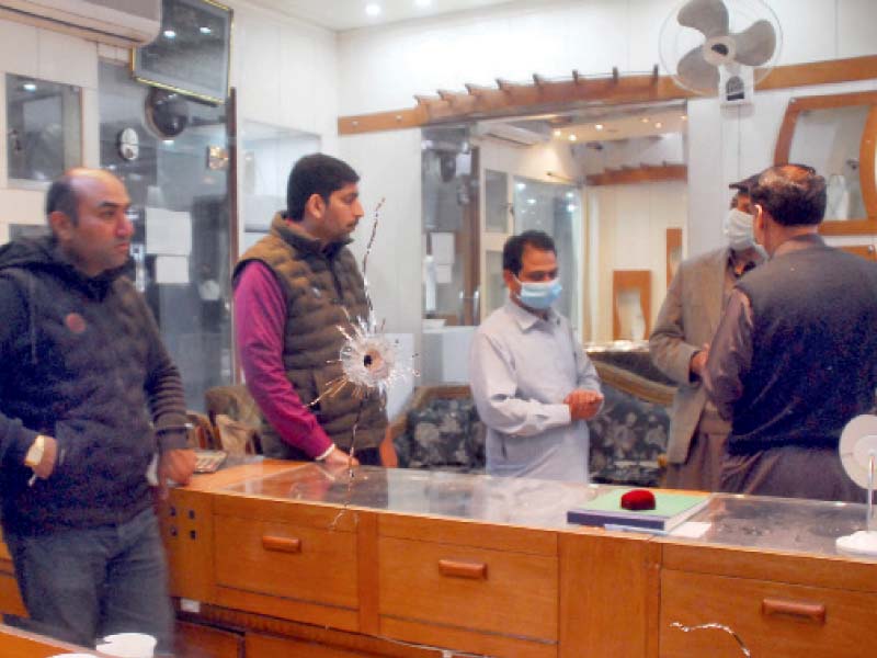 people stand in the jeweller shop in the melody market where an armed robbery took place on tuesday photo online