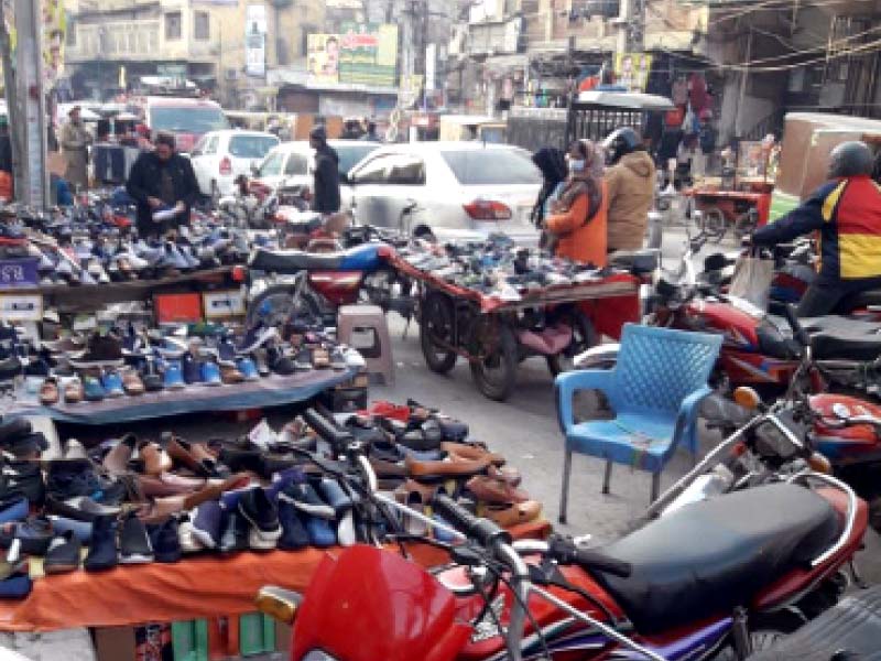 vendors have set up stalls of shoes on a street in rawalpindi which according to local traders is possible on payment of grati fication to rmc officials photo express