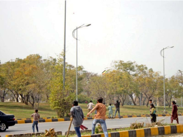 youngsters run after a falling kite on the busy 7th avenue in the federal capital photo online youngsters run after a falling kite on the busy 7th avenue in the federal capital photo online