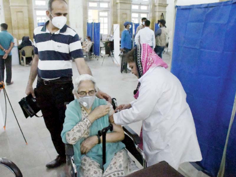 a woman is vaccinated against the coronavirus at khaliq dina hall in karachi the inoculation of persons above the age of 70 on a walk in basis began on tuesday photo online