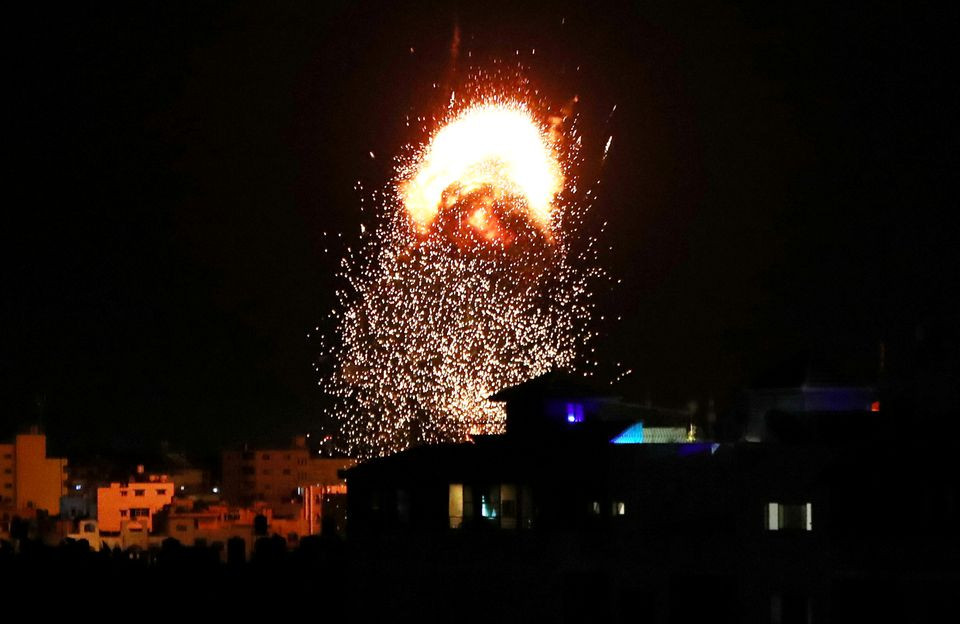 Smoke and flames rise above a building during Israeli air strikes, amid a flare-up of Israeli-Palestinian fighting, in Gaza City May 17, 2021. PHOTO: REUTERS