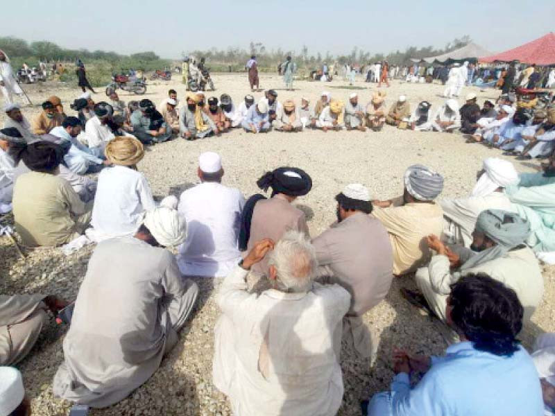 a group of tribal elders are discussing the agenda before the negotiations with authorities photo express