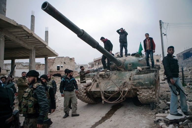 a file photo of syrian rebels gather around a t 72 tank captured from government forces photo afp