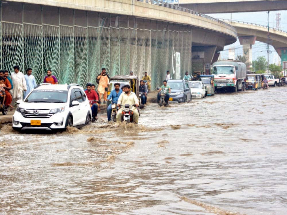 lightning streaked through the night sky as rain poured over the metropolis on friday commuters navigated through inundat ed roads and choked arteries as rain water accumulated in different parts of the city photos jalal qureshi express