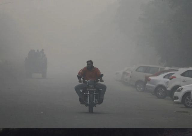a man rides a motorbike along a road shrouded in smog in noida india november 5 2021 reuters a man rides a motorbike along a road shrouded in smog in noida india november 5 2021 reuters