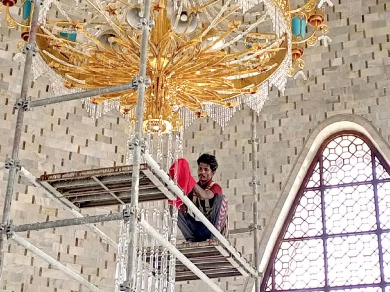 workers shine and polish fixtures at mazar i quaid photos express