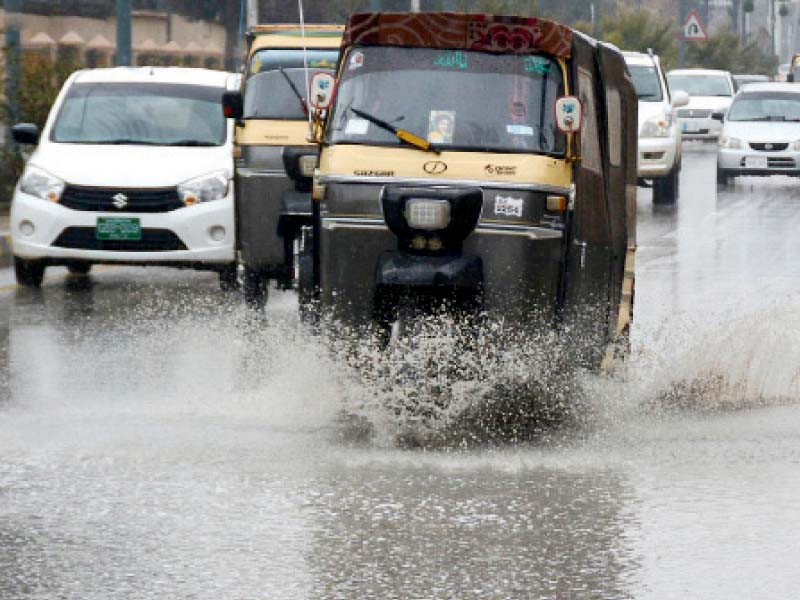 vehicles pass through accumulated water during rain in the provincial capital of quetta a tree in ziarat valley is covered in snow photos inp