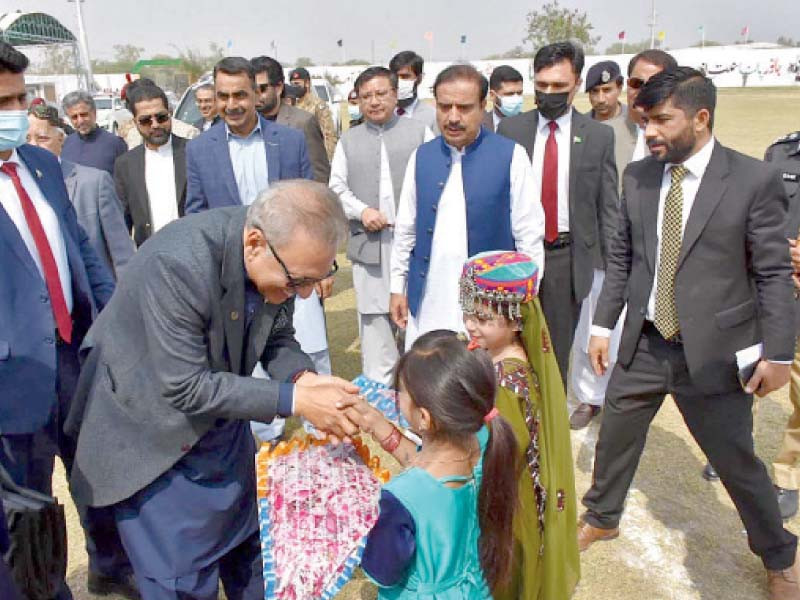 baloch girls dressed in traditional clothes present a bouquet to president alvi upon his arrival at the sibbi mela photo app