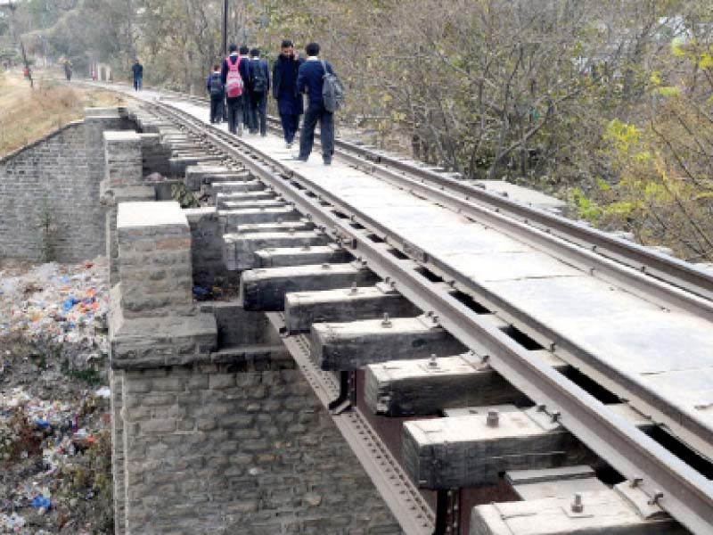 students cross the crumbling railway bridge in dhok chiragdin rawalpindi photo agha mahroz express