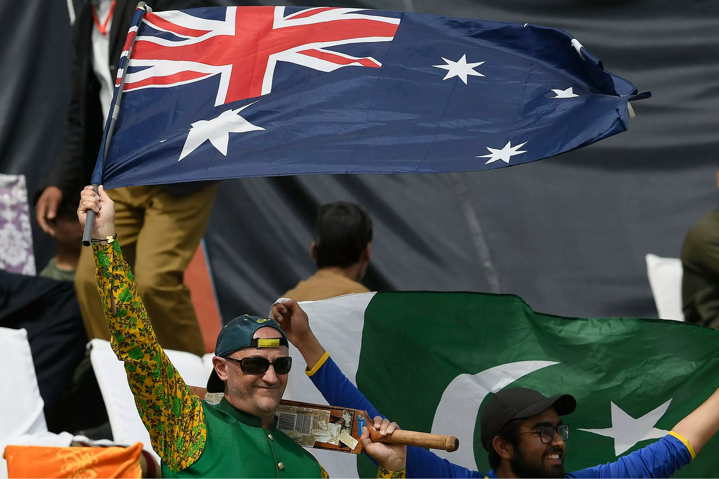 Flag bearer: Luke Gillian waves his support for Australia. AFP