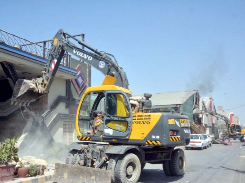 sbca officials use excavators to tear down illegally constructed marriage halls on korangi road in karachi file photo by jalal qureshi express