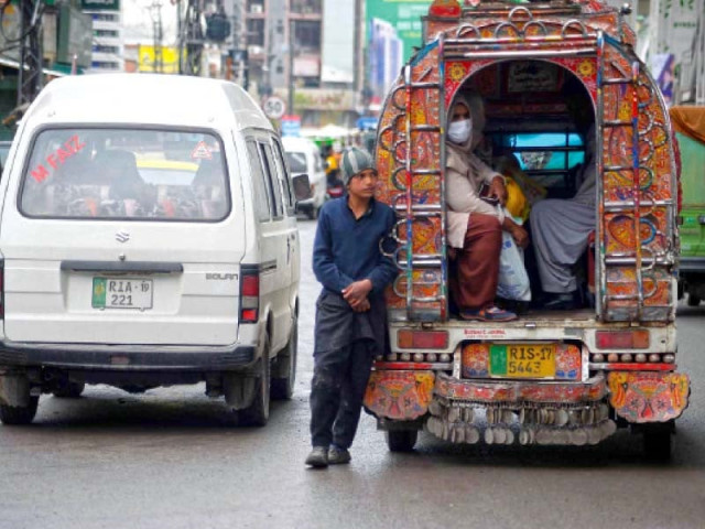 a teenage boy works as a suzuki van conductor in rawalpindi photo agha mahroz express