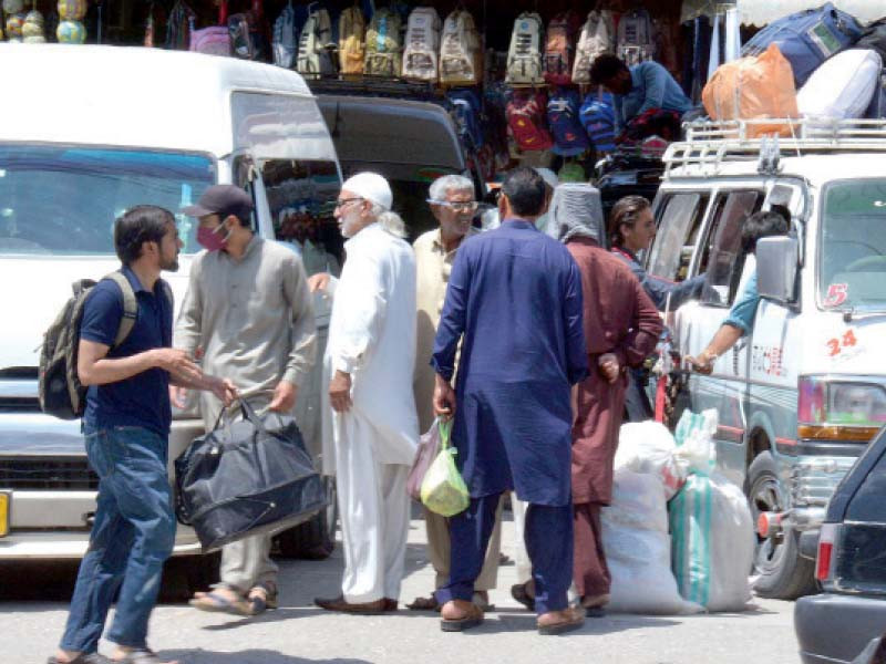 passengers board buses and vans at faizabad to depart for their hometowns to celebrate eid with their loved ones photo inp