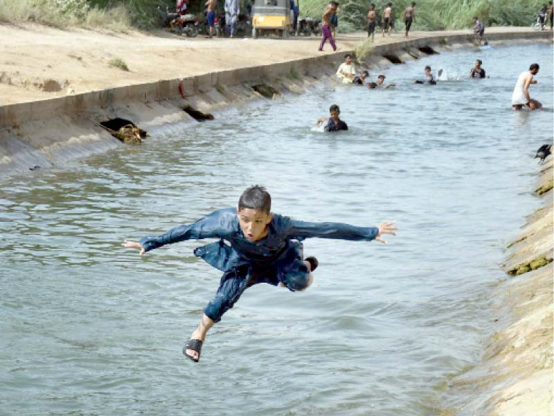 a boy jumps into a channel of the hub canal which supplies water to karachi from balochistan photo online