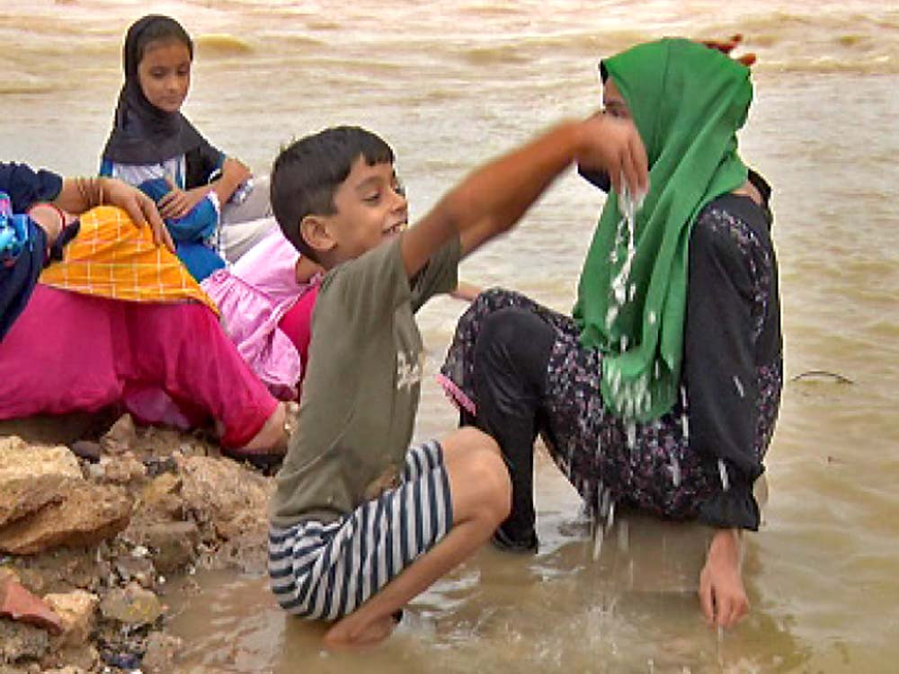 children splash on korangi causeway while a man stands in his house which collapsed in memon goth whereas the indus river has broken its banks in sukkur photos express agencies