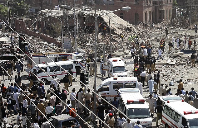 police and rescue workers gather at the site of a bomb attack in lahore on may 27 2009 photo reuters file