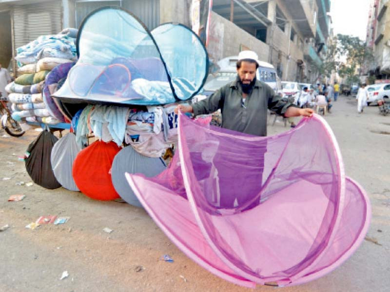 a vendor sells mosquito nets at a neighbourhood near the korangi nullah the city has witnessed a spike in dengue fever cases photo jalal qureshi express