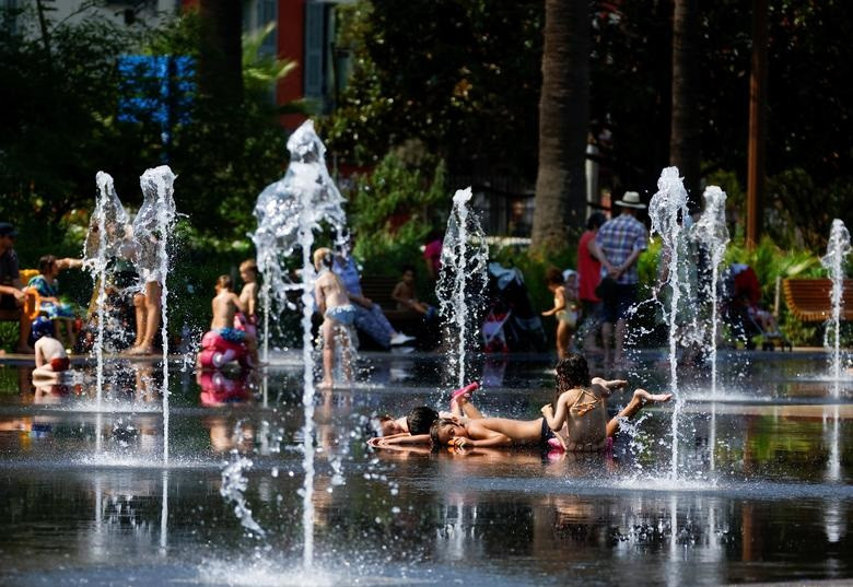 Children cool off in a fountain in Nice as a heat wave hits France, July 18.  REUTERS/Eric Gaillard