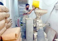 a worker puts wheat in a machine to make flour at a shop in a karachi neighbourhood photo jalal qureshi express a worker puts wheat in a machine to make flour at a shop in a karachi neighbourhood photo jalal qureshi express