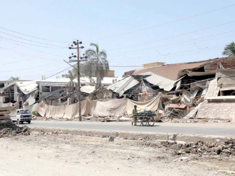 people drive past the wedding halls demolished by sindh building control authority in the gulberg area of karachi these commercial structured were built on residential plots photo jalal qureshi file