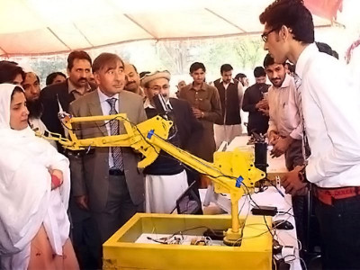 inventive thinking student displays prototype of bomb defusing robot