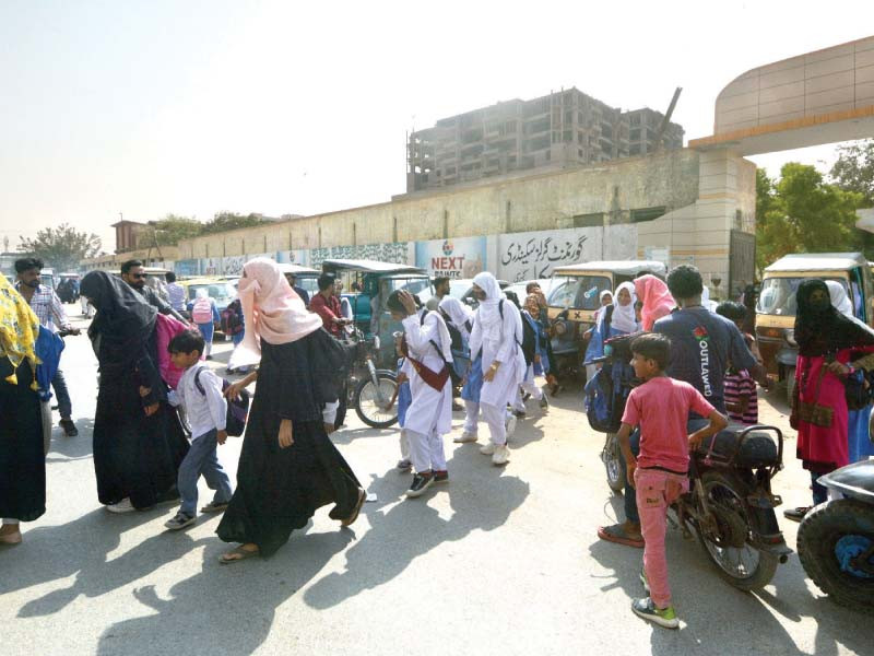 students of govt girls secondary school jacob lines head home after school inflation hit people in the area are transferring their children from private and trust operated schools to government institutions offering zero tuition fee and free textbooks photo jalal qureshi express