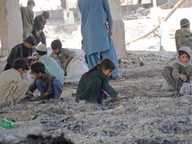 children gathered at new sabzi mandi on thursday afternoon to look through the debris left behind by a massive fire on wednesday photo rashid ajmeri express children gathered at new sabzi mandi on thursday afternoon to look through the debris left behind by a massive fire on wednesday photo rashid ajmeri express