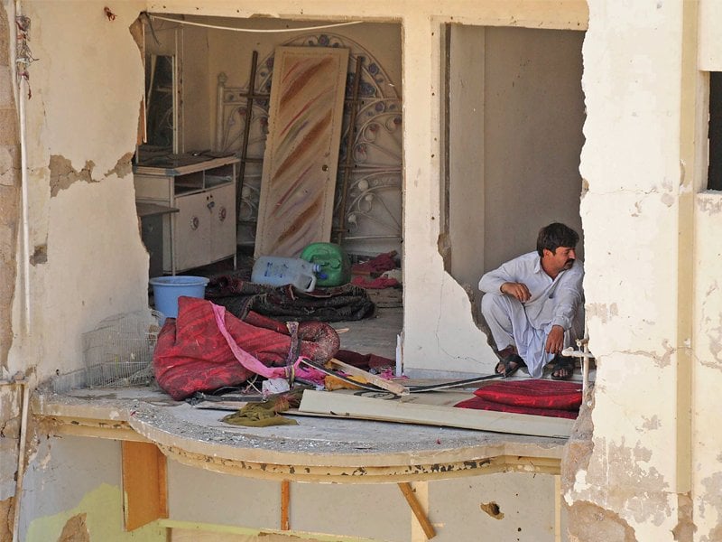 survivors of the bomb blast in abbas town rummage through their belongings four days after the incident the government has announced that it will reconstruct the buildings but the work has yet to start photo rashid ajmeri express